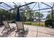 Relaxing screened patio with lounge chairs and views of the lush garden and waterway at 4469 Old Bear Run, Winter Park, FL 32792