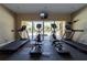 Community gym featuring treadmills and elliptical machines with an exterior view of the pool at 4874 Matteo Trl, Orlando, FL 32839