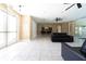Common area lounge featuring tile flooring, leather sofas and access to the community kitchen and gym at 4874 Matteo Trl, Orlando, FL 32839