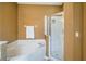 Bright bathroom featuring a soaking tub and a glass enclosed shower stall at 5201 Lake Marion Golf Resort # 5201, Kissimmee, FL 34759