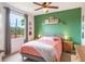Bedroom with a green accent wall and a large window overlooking the greenery at 5201 Lake Marion Golf Resort # 5201, Kissimmee, FL 34759
