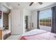 Bright bedroom featuring ceiling fan, neutral carpet, and large window at 5201 Lake Marion Golf Resort # 5201, Kissimmee, FL 34759