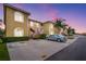 Condo building with well-kept landscaping, red stair accents, and ample parking under a beautiful twilight sky at 5201 Lake Marion Golf Resort # 5201, Kissimmee, FL 34759