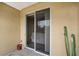 Cozy patio entrance featuring a sliding glass door and charming potted cactus at 5201 Lake Marion Golf Resort # 5201, Kissimmee, FL 34759