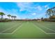 Community tennis courts provide ample space and green landscaping for outdoor activities at 5201 Lake Marion Golf Resort # 5201, Kissimmee, FL 34759