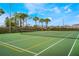 Community tennis court features professional netting and well-kept landscaping at 5201 Lake Marion Golf Resort # 5201, Kissimmee, FL 34759