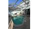The refreshing screened-in pool features a brick patio, and comfortable seating for outdoor relaxation at 7661 Fitzclarence St, Kissimmee, FL 34747
