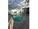 Relaxing screened-in pool features brick pavers and outdoor seating in a private backyard at 7661 Fitzclarence St, Kissimmee, FL 34747