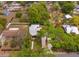 Aerial view of the property showing the landscaping, yard, and the surrounding neighborhood at 1010 N Clayton St, Mount Dora, FL 32757