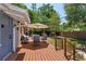 Backyard deck with outdoor seating, umbrella, and access to the grassy yard with a playset at 1010 N Clayton St, Mount Dora, FL 32757