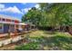 Spacious backyard featuring multiple outdoor areas, including a deck, dining space, and playground at 1010 N Clayton St, Mount Dora, FL 32757