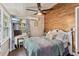 Cozy bedroom featuring a workspace, light-colored walls, and wooden accent wall at 1010 N Clayton St, Mount Dora, FL 32757