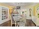 Bright dining room with decorative accents, fireplace, and wood floors, perfect for Gathering meals and entertaining guests at 1010 N Clayton St, Mount Dora, FL 32757