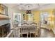 Elegant dining room with stylish chandelier, fireplace and wood floors perfect for entertaining and Gathering meals at 1010 N Clayton St, Mount Dora, FL 32757