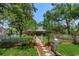 Charming red single-story home with a white picket fence, enhancing its curb appeal and inviting atmosphere at 1010 N Clayton St, Mount Dora, FL 32757