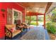 Inviting front porch with comfortable seating, ceiling fan, and charming decor at 1010 N Clayton St, Mount Dora, FL 32757