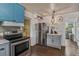 Bright kitchen featuring stainless steel appliances and gray painted cabinetry at 1010 N Clayton St, Mount Dora, FL 32757