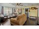 Inviting living room with coffered ceilings, wood floors, and ample natural light, creating a cozy and stylish atmosphere at 1010 N Clayton St, Mount Dora, FL 32757