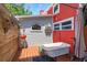 Unique outdoor bath area with a clawfoot tub, shower, and decorative elements at 1010 N Clayton St, Mount Dora, FL 32757