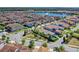 An aerial view of a beautiful community with homes surrounding a central lake at 10399 Macduff Dr, Orlando, FL 32832