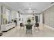 Open-concept dining area featuring a modern glass table, stylish chairs, and elegant chandelier at 10399 Macduff Dr, Orlando, FL 32832