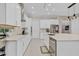 Bright kitchen featuring white cabinetry, stainless steel appliances, and ample counter space at 10399 Macduff Dr, Orlando, FL 32832