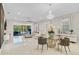 Bright living room with a glass sliding door, an elegant chandelier, and modern decor at 10399 Macduff Dr, Orlando, FL 32832
