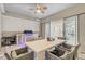 Covered outdoor patio area includes a dining table, grill, and sliding doors leading to the living room at 10399 Macduff Dr, Orlando, FL 32832
