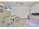 A view of the covered patio with dining area, TV, and outdoor grill at 10399 Macduff Dr, Orlando, FL 32832