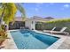 Relax in this private backyard featuring a pool, outdoor seating, and tropical landscaping at 10399 Macduff Dr, Orlando, FL 32832