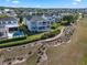 Beautiful aerial view of a landscaped backyard with pool and a two-story home with screened porches at 1224 Union Club Dr, Winter Garden, FL 34787
