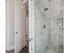 Modern bathroom with walk-in shower featuring gray and white tile and a frameless glass door at 1224 Union Club Dr, Winter Garden, FL 34787