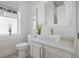 Bright bathroom featuring a vessel sink, modern fixtures, and natural light from the window at 1224 Union Club Dr, Winter Garden, FL 34787