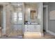 Luxurious bathroom features a glass-enclosed shower, modern vanity, and stone backsplash at 1224 Union Club Dr, Winter Garden, FL 34787