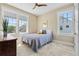 Cozy bedroom with a large window, ceiling fan, and soft, neutral carpet, creating a relaxing atmosphere at 1224 Union Club Dr, Winter Garden, FL 34787