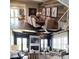 Bright dining room with wood accent wall joins light-filled living room with fireplace and dark trim at 1224 Union Club Dr, Winter Garden, FL 34787