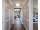 Hallway with decorative wall paneling and hardwood flooring, leading to rooms with ample natural light at 1224 Union Club Dr, Winter Garden, FL 34787