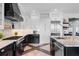 Modern kitchen with stainless appliances, white cabinets, and a sleek black range hood at 1224 Union Club Dr, Winter Garden, FL 34787