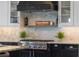 Close up of gourmet stove and hood complimented by a subway tile backsplash and pot filler at 1224 Union Club Dr, Winter Garden, FL 34787
