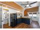 Stylish kitchen with wood countertops, floating shelves, and modern retro refrigerator with a view into the bathroom at 1224 Union Club Dr, Winter Garden, FL 34787