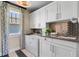 Well-equipped laundry room with white cabinetry, sleek countertops, and modern appliances at 1224 Union Club Dr, Winter Garden, FL 34787