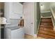 Efficient laundry area with stacked washer/dryer unit and convenient access to the stairs at 1224 Union Club Dr, Winter Garden, FL 34787
