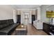 Open-concept living room with hardwood floors and stylish furniture with a view of the front hall at 1224 Union Club Dr, Winter Garden, FL 34787