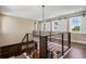 Modern loft with stylish black metal and wood banister overlooking the floor below and windows with barn door coverings at 1224 Union Club Dr, Winter Garden, FL 34787
