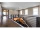 A spacious loft area features hardwood floors, a modern chandelier, and large windows for natural light at 1224 Union Club Dr, Winter Garden, FL 34787