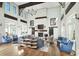Spacious lounge with a fireplace, wooden floors, exposed beams, white brick accents, and comfortable seating at 1224 Union Club Dr, Winter Garden, FL 34787