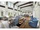 Open-concept community lounge with high ceilings, exposed beams, fireplace and beautiful hardwood flooring at 1224 Union Club Dr, Winter Garden, FL 34787