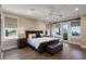 A serene main bedroom features hardwood floors, a dark wood bed frame, and picturesque outdoor views at 1224 Union Club Dr, Winter Garden, FL 34787