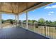 Outdoor patio area features black metal railings and a scenic green view with a glimpse of the water at 1224 Union Club Dr, Winter Garden, FL 34787
