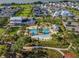 Aerial view of community resort style zero entry pool with palm trees and beach area with lake views at 1224 Union Club Dr, Winter Garden, FL 34787